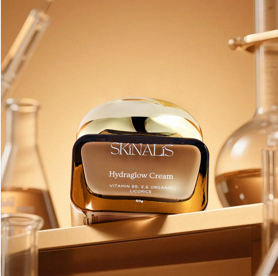 Skinalis Hydraglow Cream jar in a warm golden skincare setting